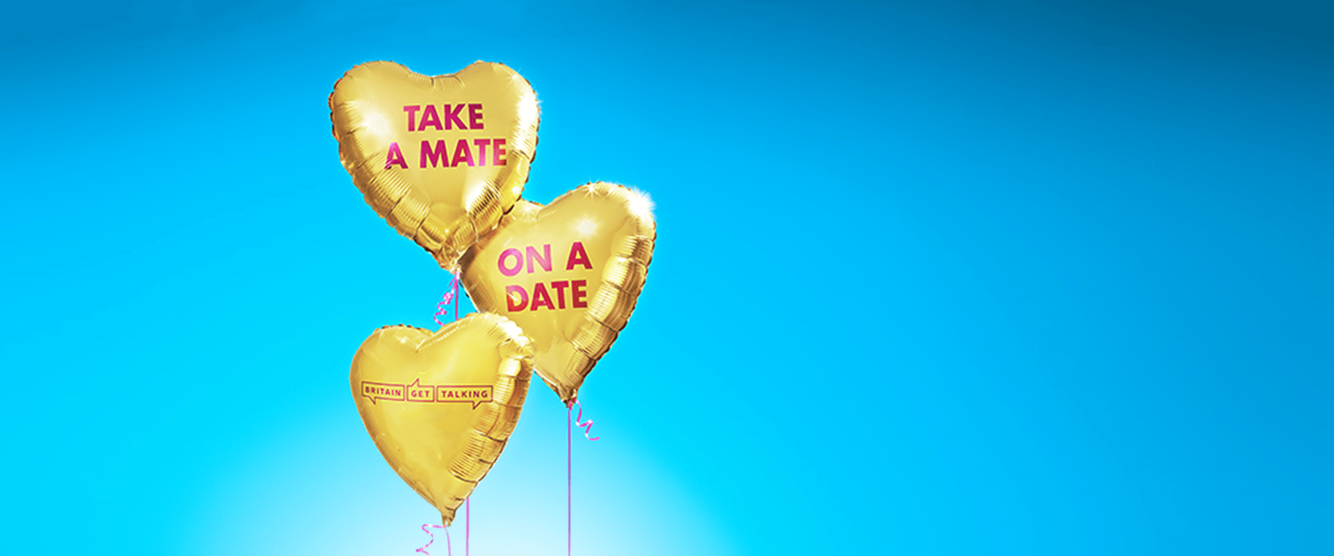 Three gold heart balloons tied by pink ribbon. On the balloons, it reads 'Take a Mate on a Date'. The Britain Get Talking logo is on the bottom heart balloon.